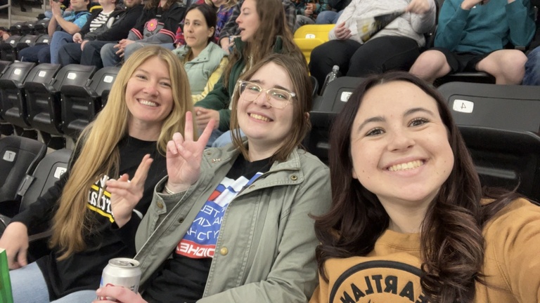 Genevieve, Cara, and Lillie at a Hockey Game